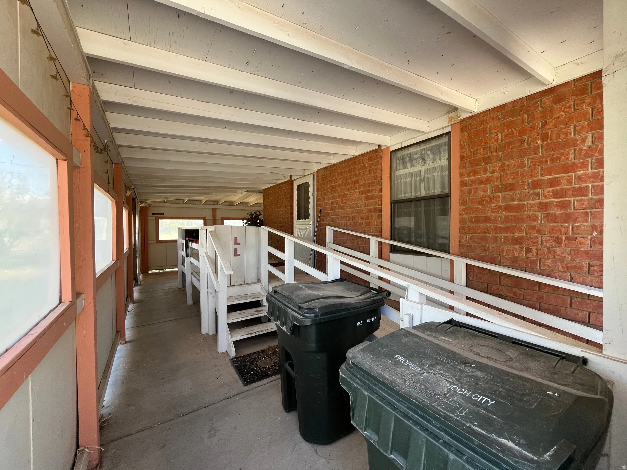 Covered porch entryway featuring a concrete floor