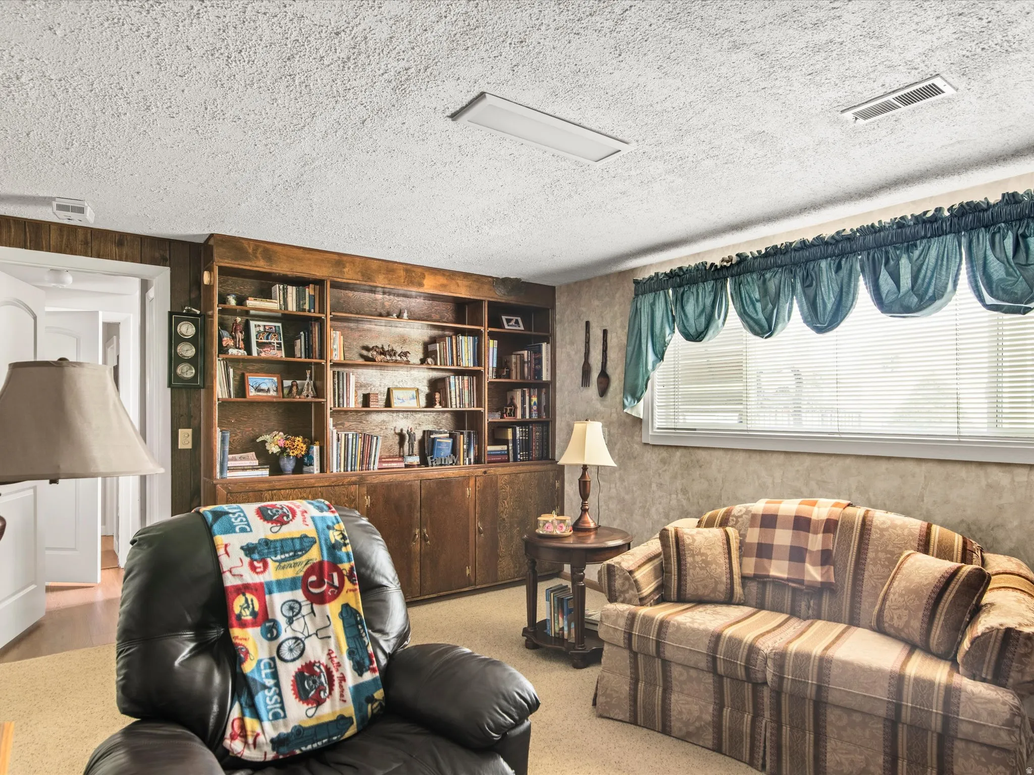 Built-in wood shelving and cabinetry providing extensive storage