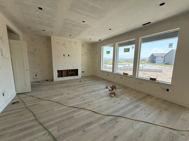 Recessed lighting, light wood-finish flooring, built-in fireplace feature, white trim, and multiple large windows