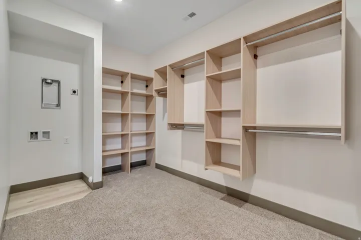 Walk in closet featuring light carpet