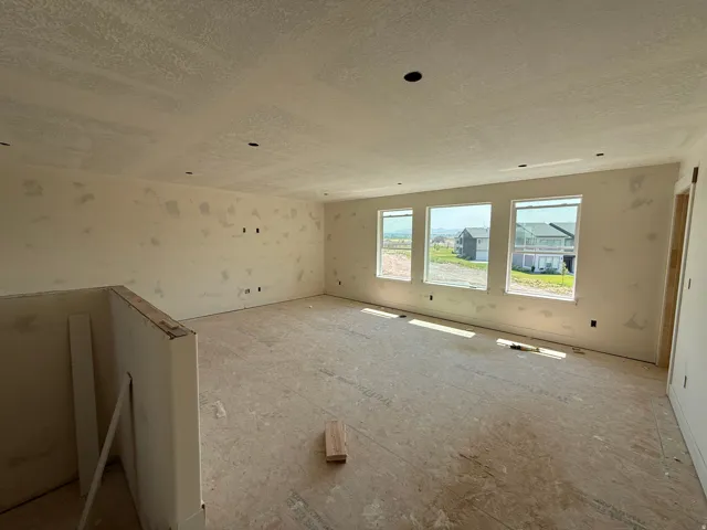 Room featuring three large windows