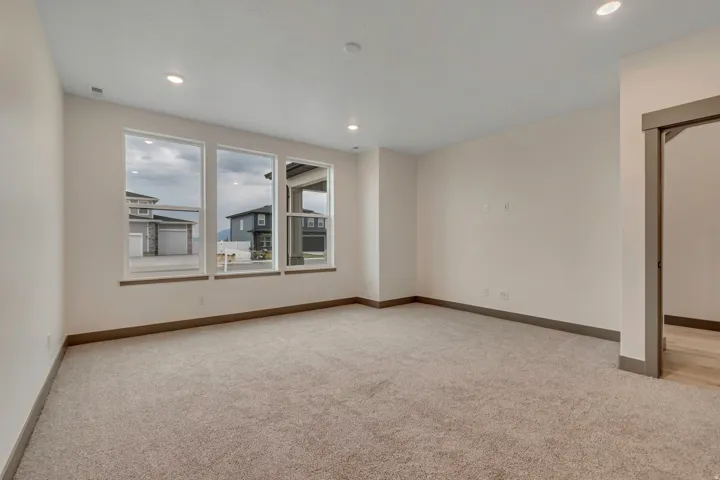 Spare room featuring light carpet and recessed lighting