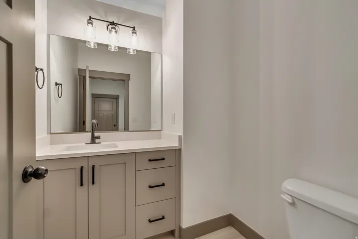 Half bathroom with vanity and toilet