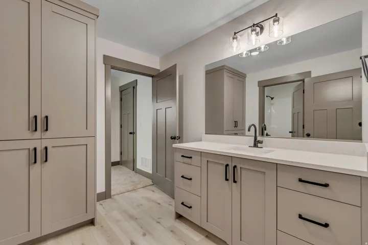 Full bathroom featuring light wood-style floors, vanity, a closet, and a shower