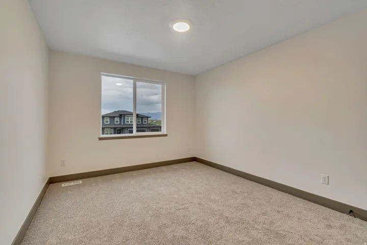 Spare room with carpet and baseboards