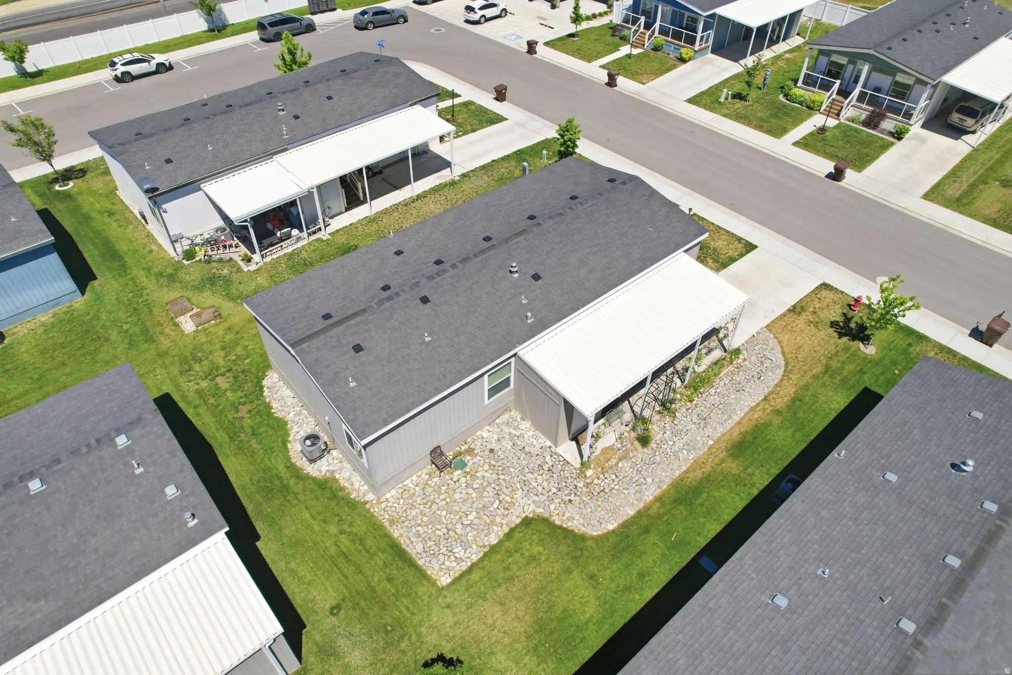 Gray siding residence with dark shingle roofing