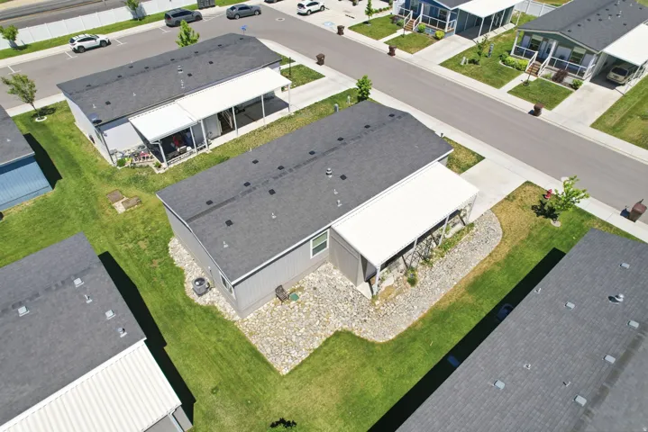 Gray siding residence with dark shingle roofing