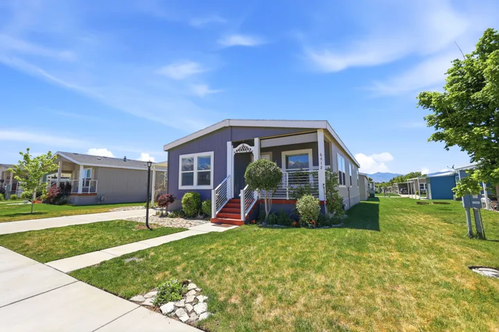 Purple exterior featuring white trim and a covered front porch