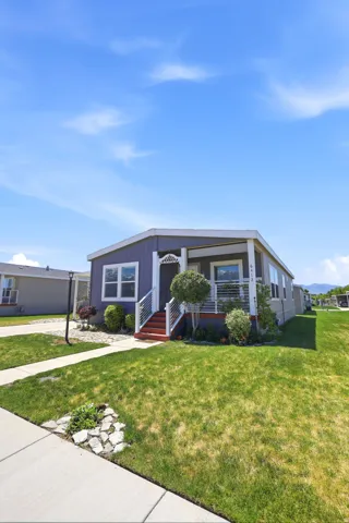 Single-story residence featuring a blue siding exterior with white trim