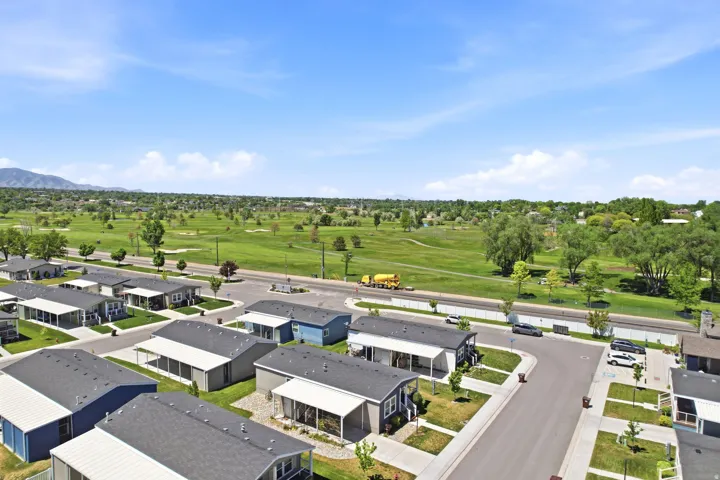 Aerial perspective showcasing a residential community with paved streets and individual home sites