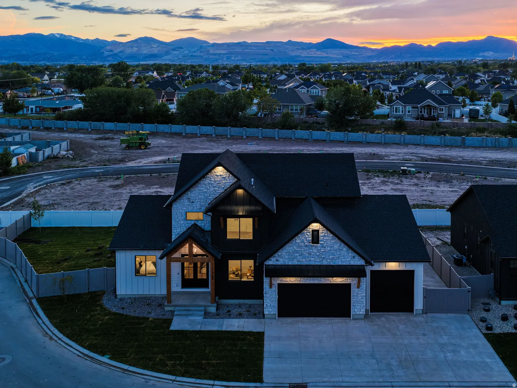 Modern residence with a striking stone and dark siding facade