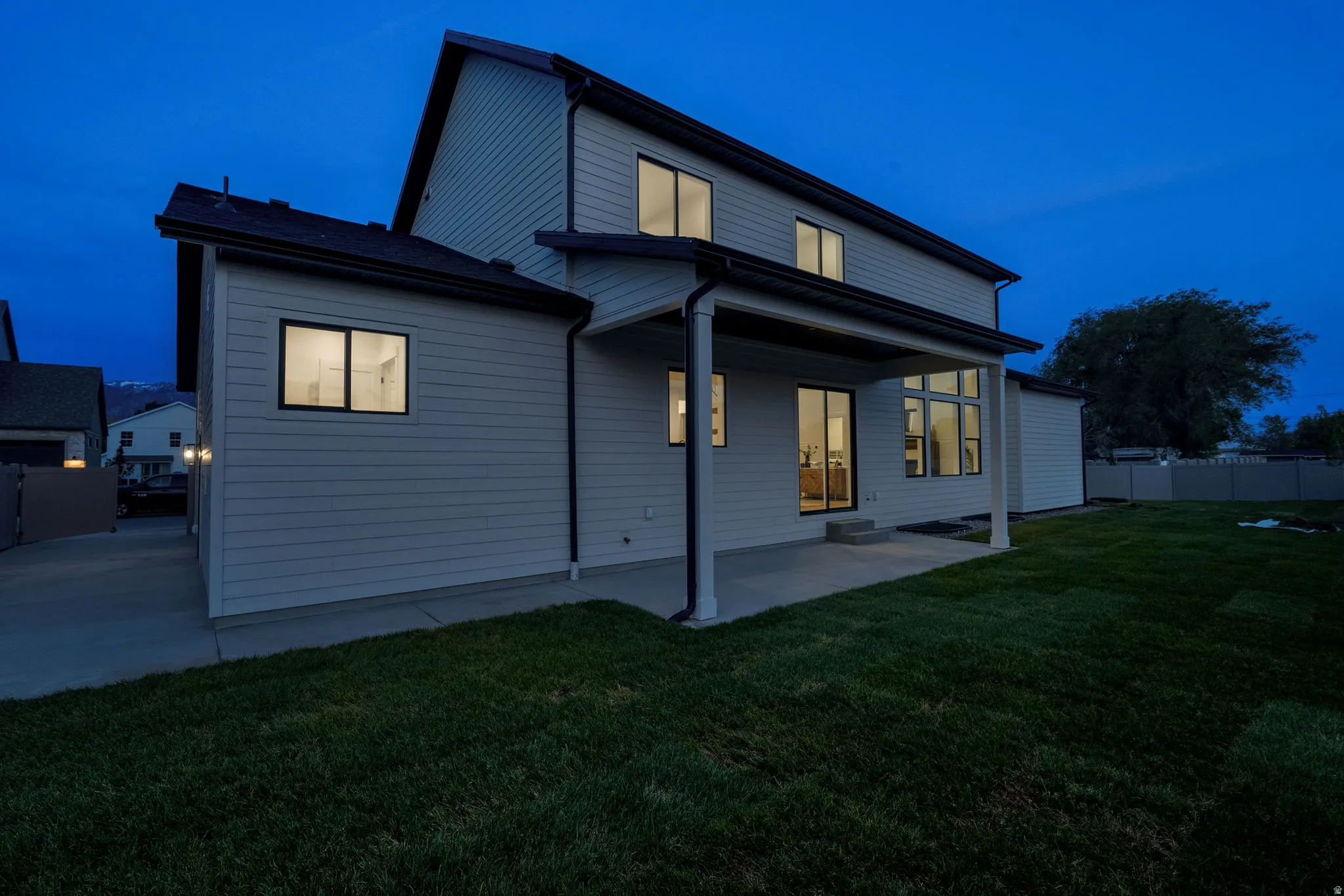 Modern two-story exterior with horizontal siding and a dark shingle roof