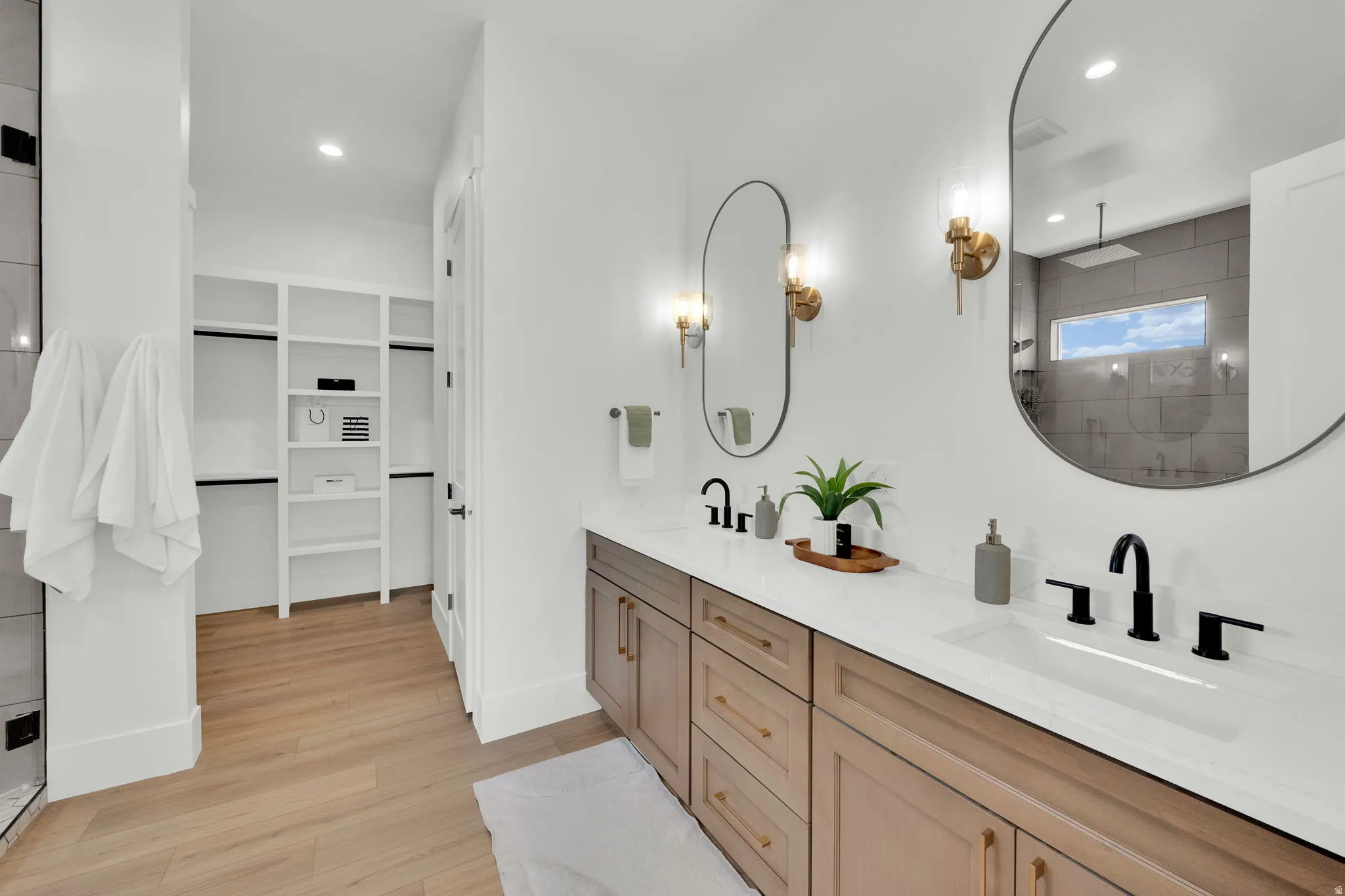 Dual vanity featuring white countertops, matte black plumbing fixtures, and integrated sinks