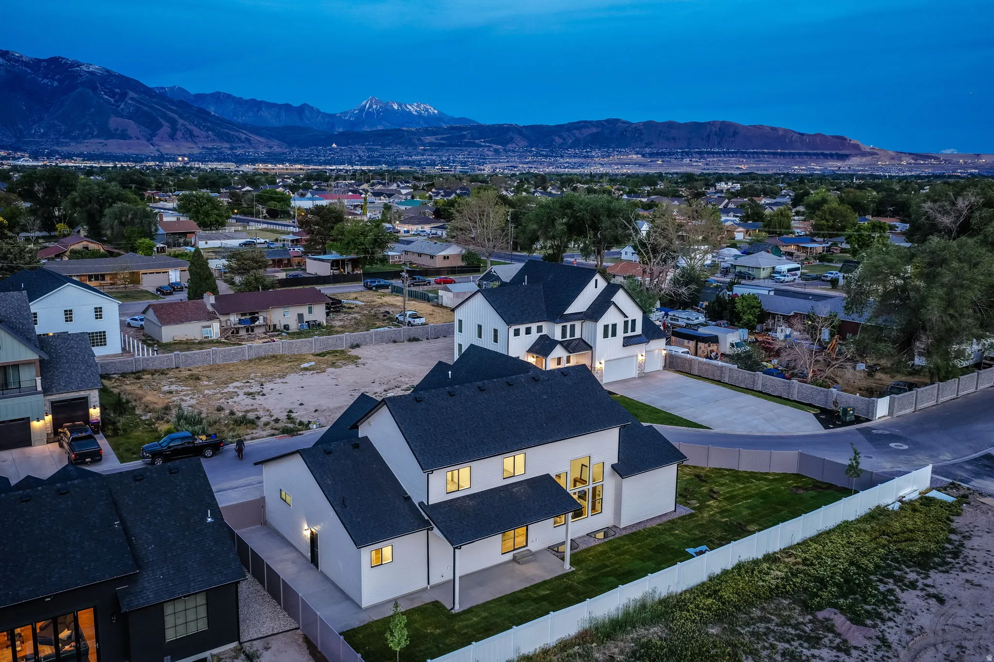 Modern residences featuring white exteriors and dark roofing