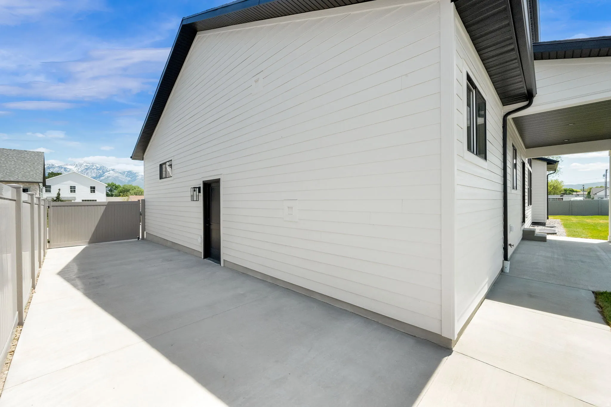White horizontal siding exterior with black trim and gutters