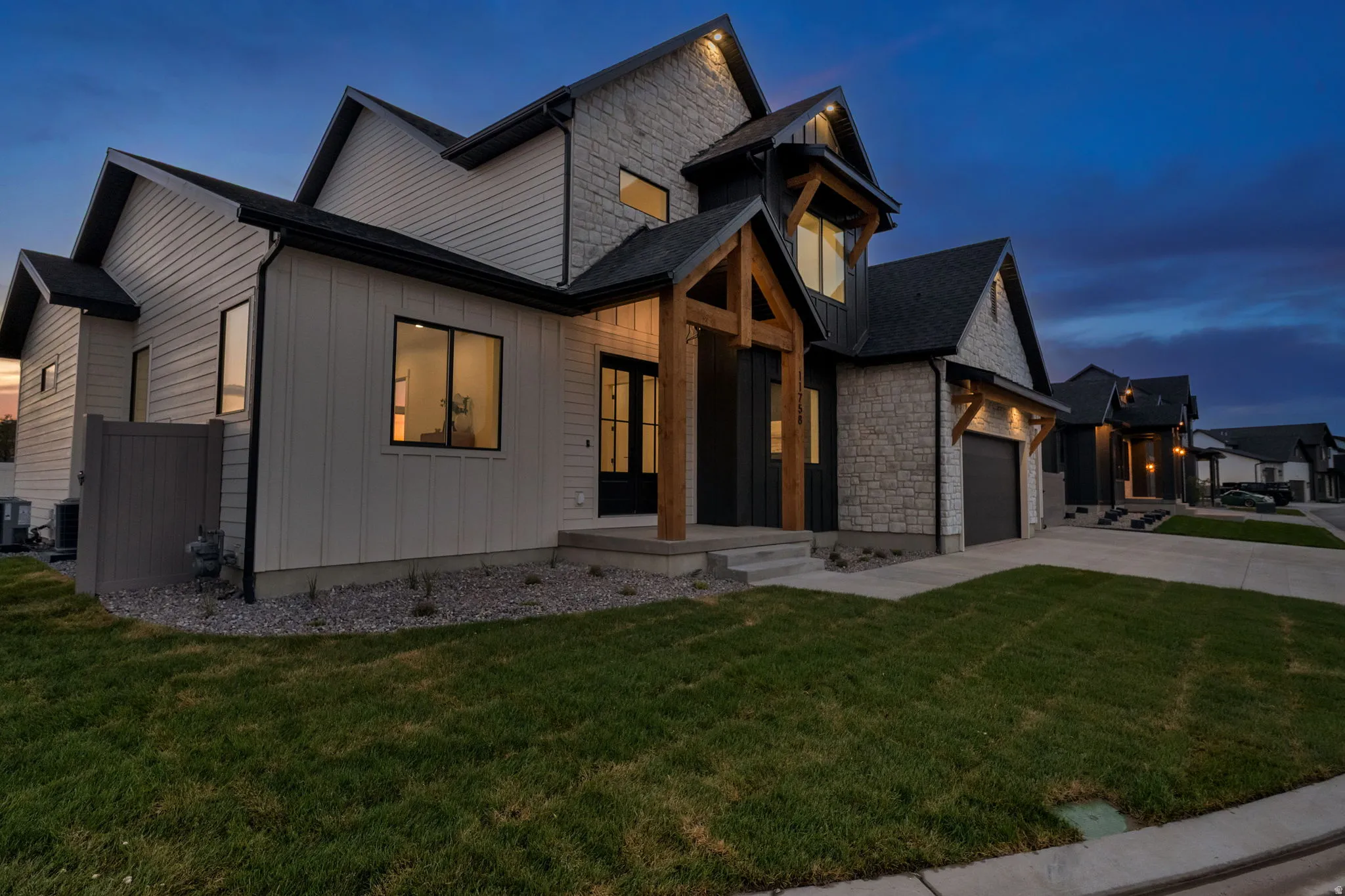 Contemporary exterior featuring stone and vertical siding accents
