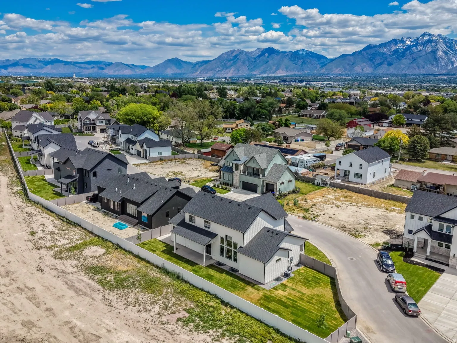 Aerial perspective showcasing a residential development with mountain scenery