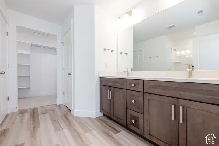 Dual vanity with dark wood-finish cabinetry and light countertops