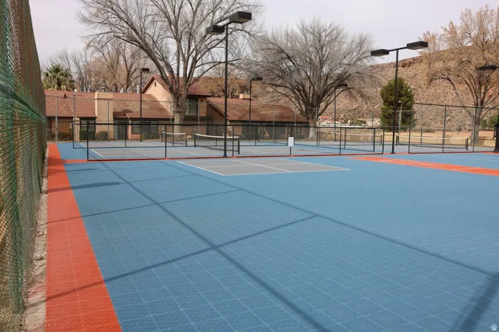 Multiple outdoor courts featuring blue and orange sport surfacing