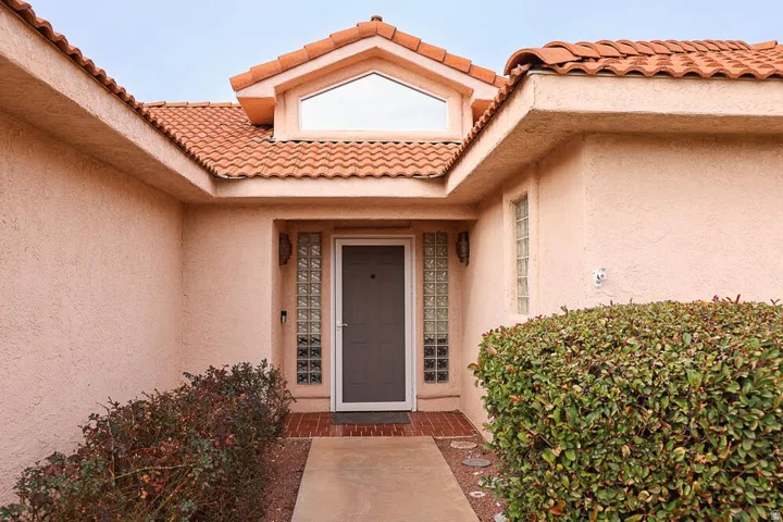 Stucco exterior featuring a terracotta tile roof