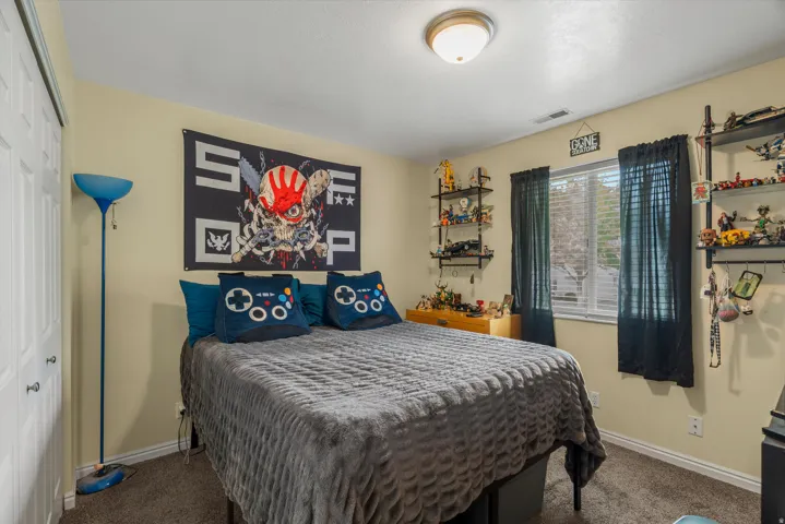 Neutral wall paint, ceiling-mounted light fixture, and a window with blinds and curtains