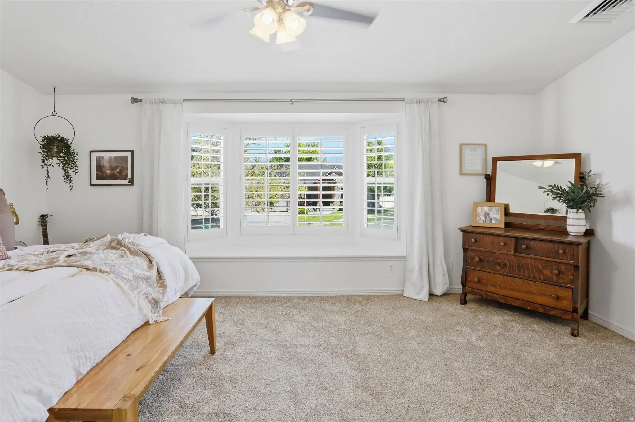 Bay window with white plantation shutters and integrated window seat