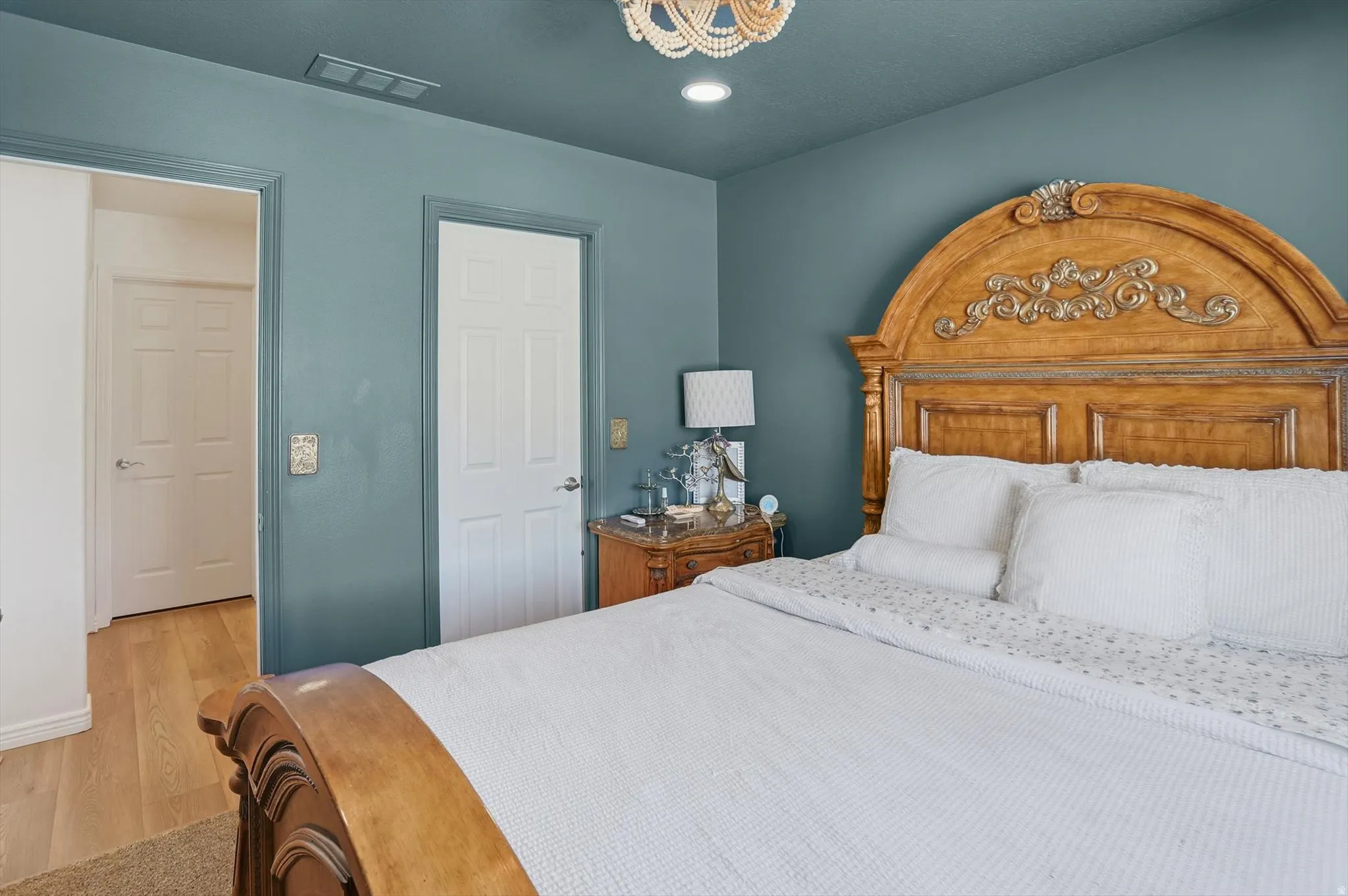 Rich teal walls featuring white trim and five-panel interior doors
