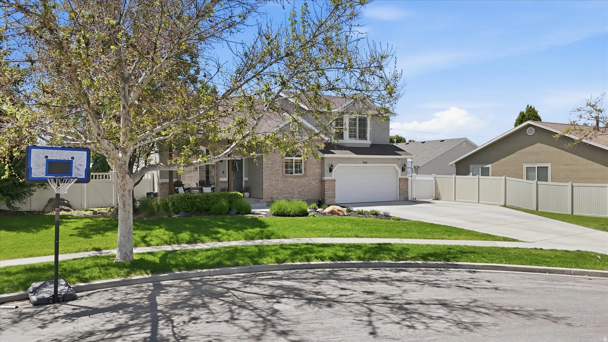 Two-story residence featuring a brick and siding exterior, an attached two-car garage, and a concrete driveway