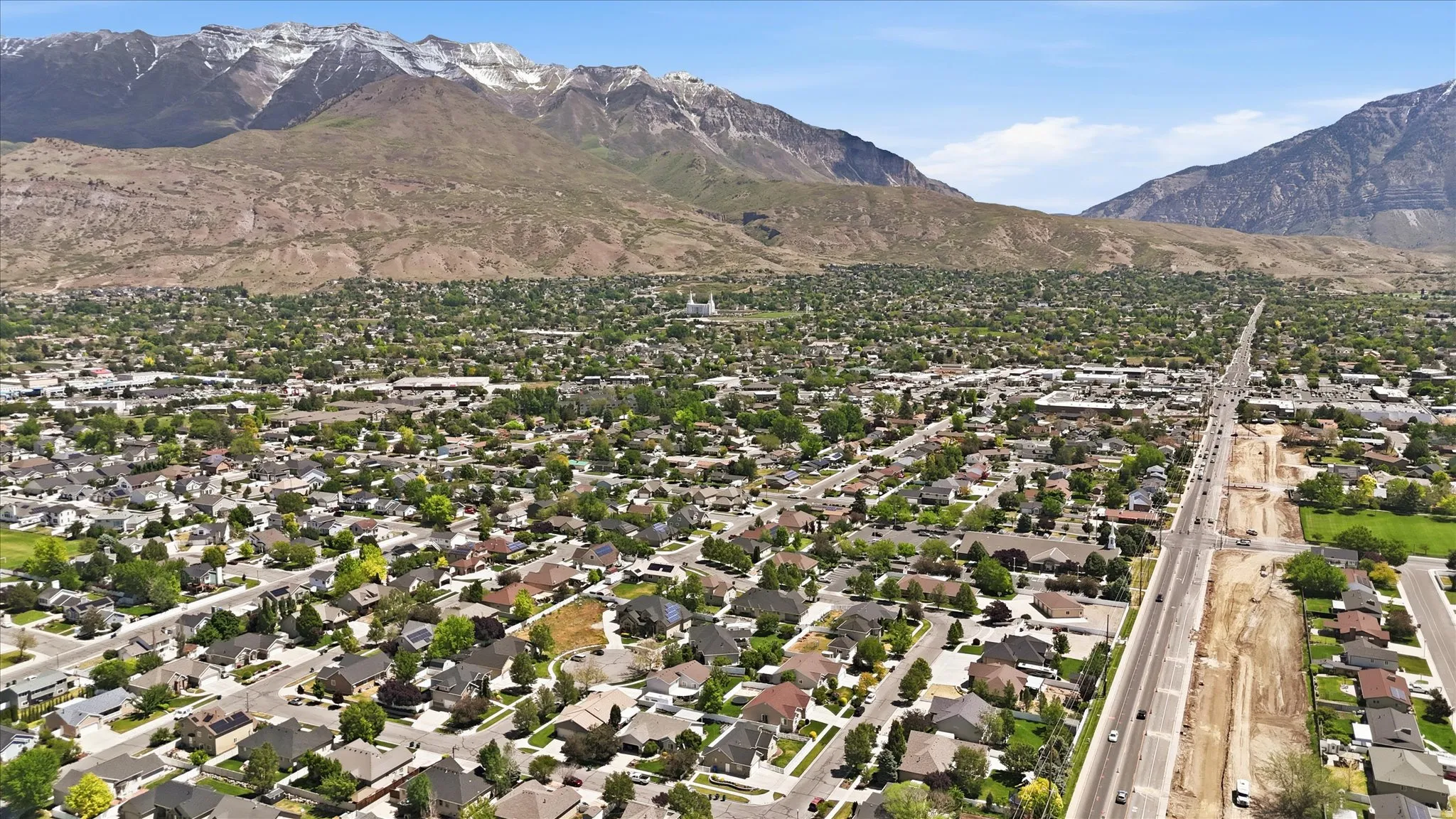 Residential landscape framed by snow-capped mountains