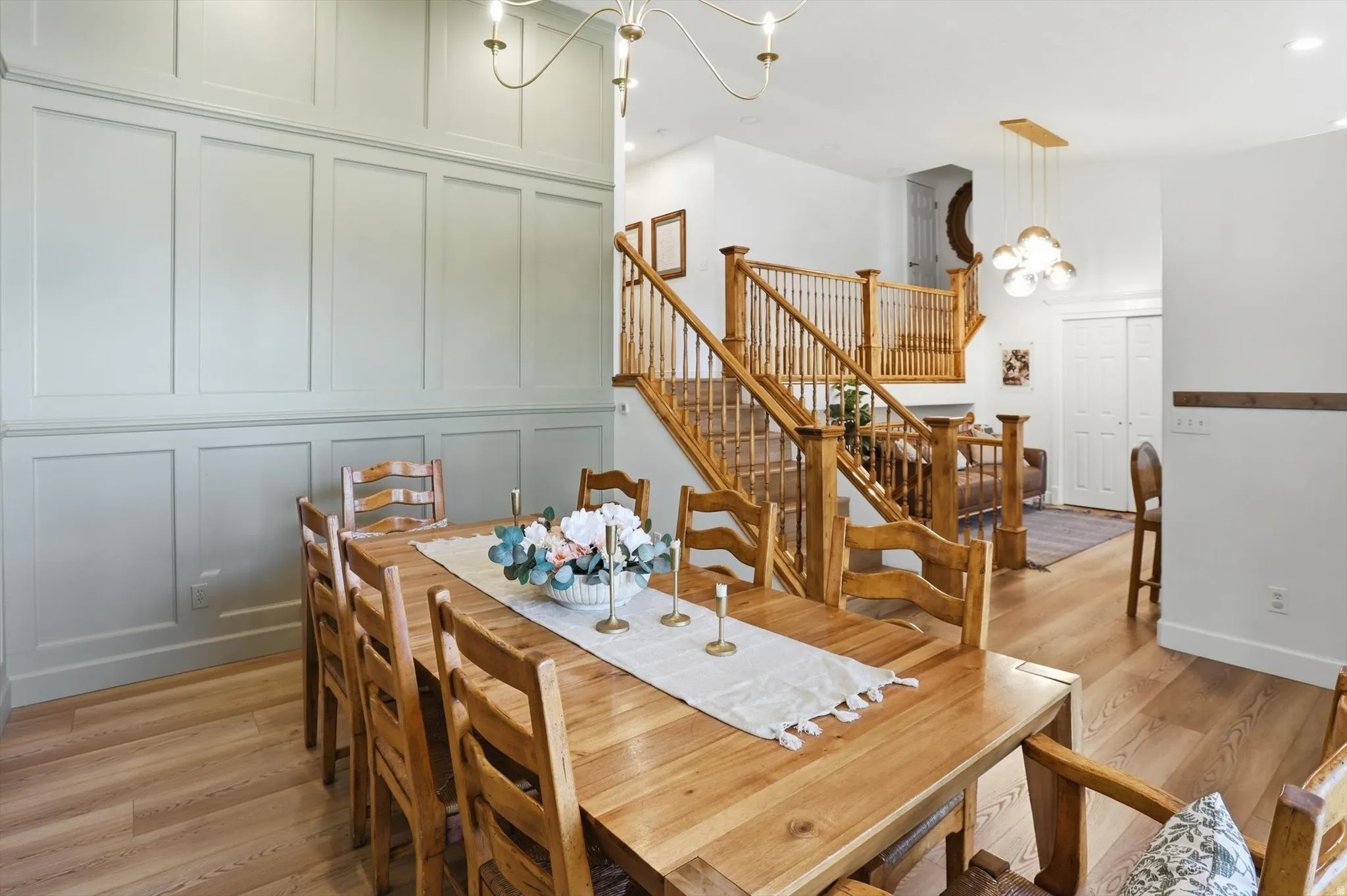 Dining area featuring light wood-finish flooring and wainscoting