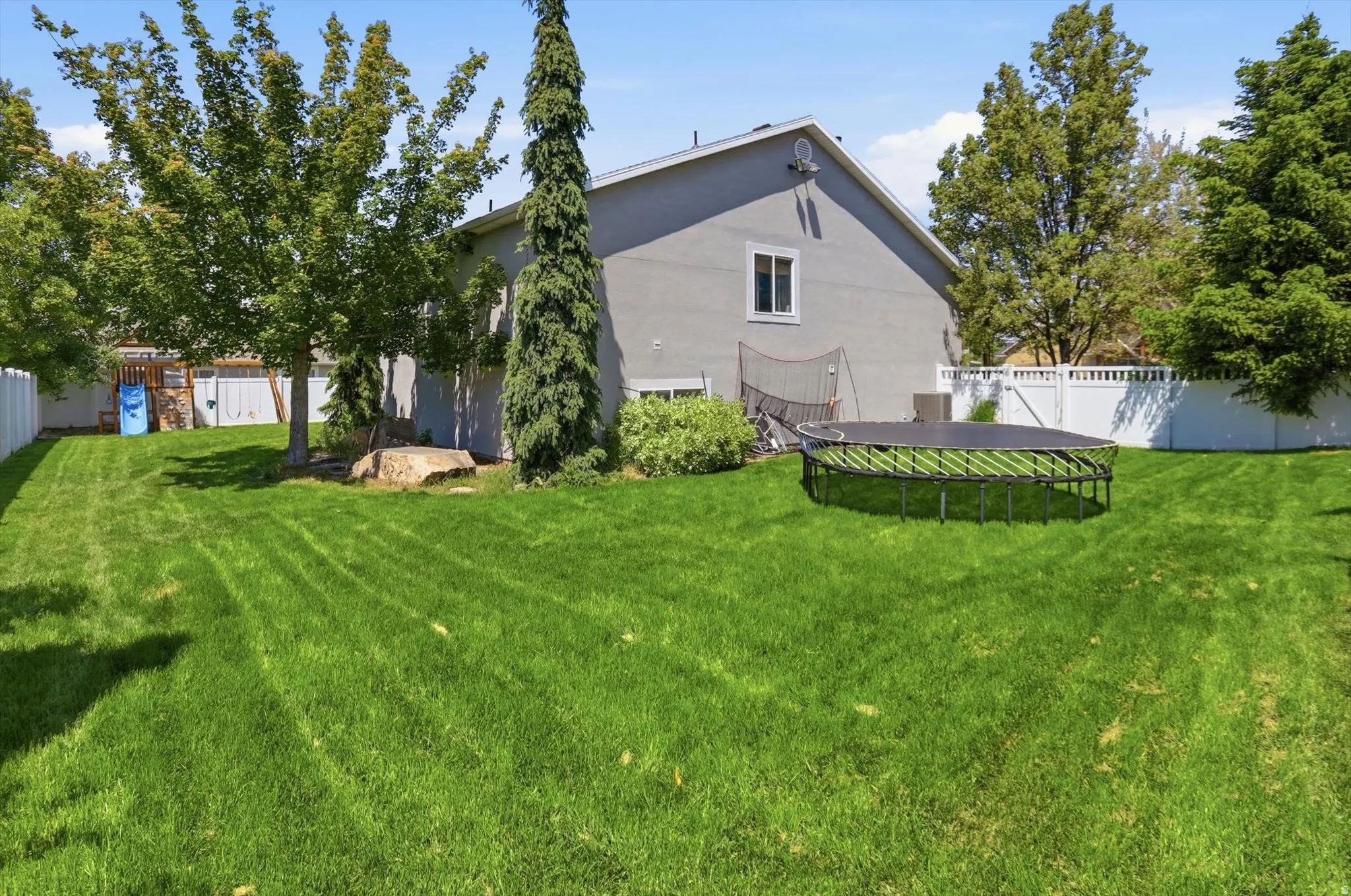 Expansive green lawn surrounds the property