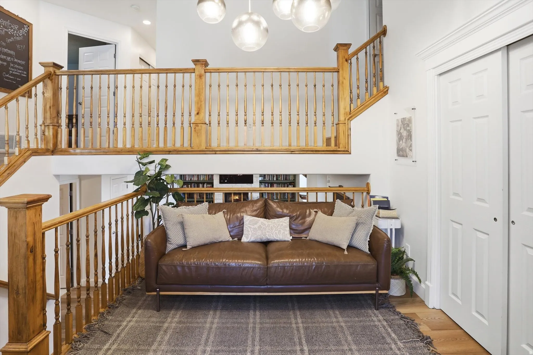 Bright open-concept interior featuring a multi-level layout with natural wood staircases and railings