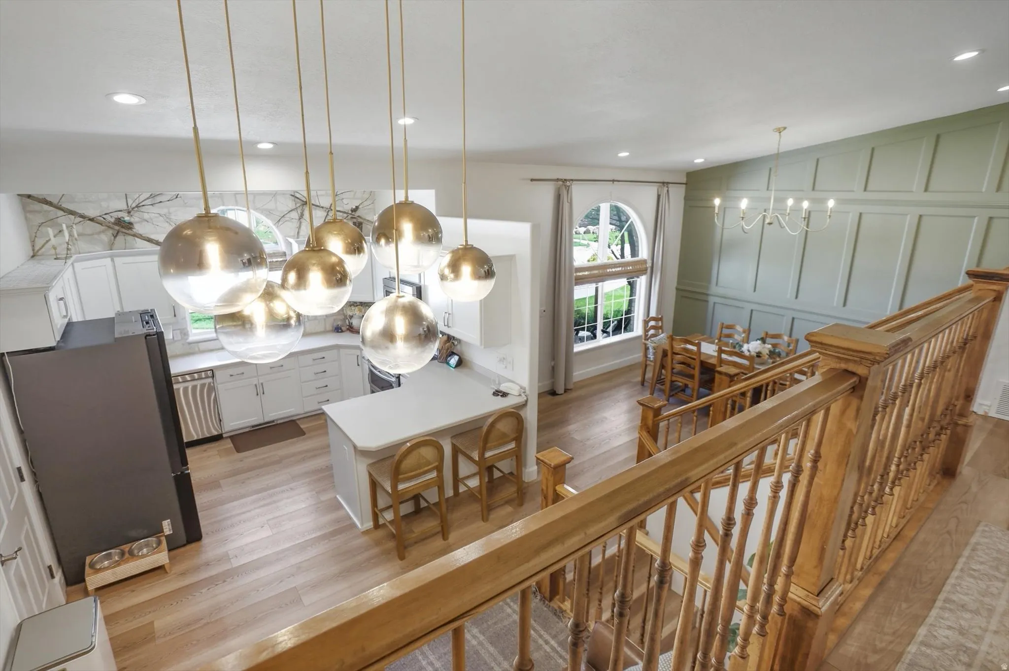 Open-concept living space with light wood-finish flooring