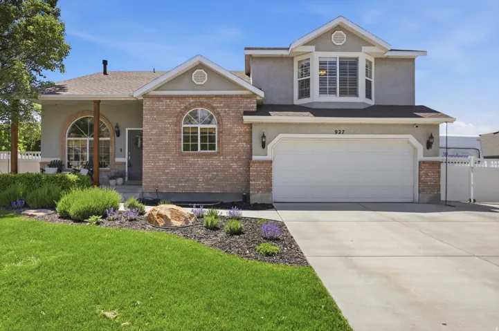 Two-story residence featuring a brick and stucco exterior