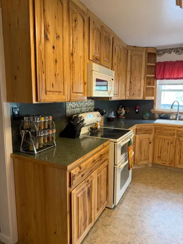 Kitchen featuring wood-finish cabinetry and speckled countertops