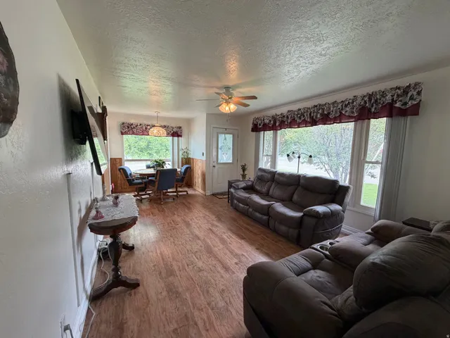 Open concept living space featuring wood-finish flooring