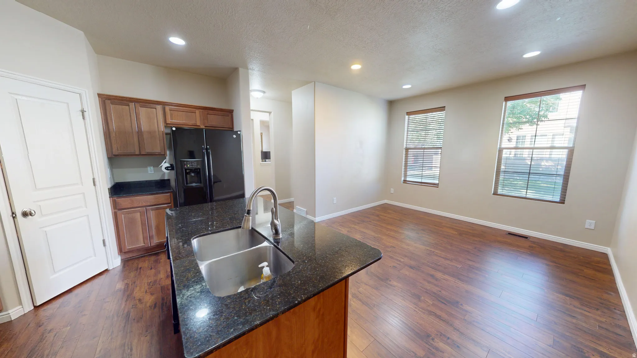 Kitchen island with a double basin stainless steel sink and a gooseneck faucet