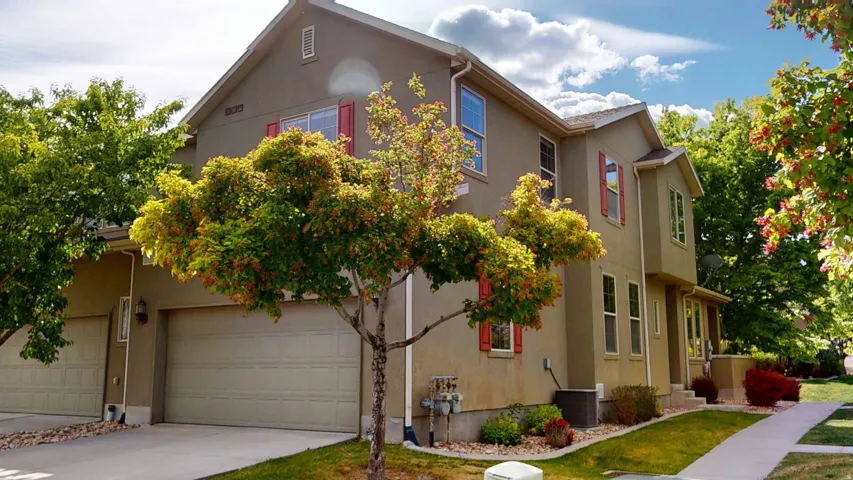 Stucco exterior featuring red window shutters