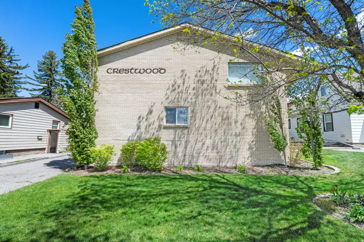 Cream-colored brick exterior with "CRESTWOOD" lettering, featuring multiple windows
