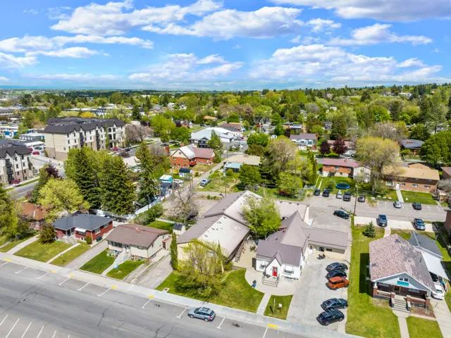 Expansive aerial perspective showcasing a neighborhood with diverse residential and commercial structures