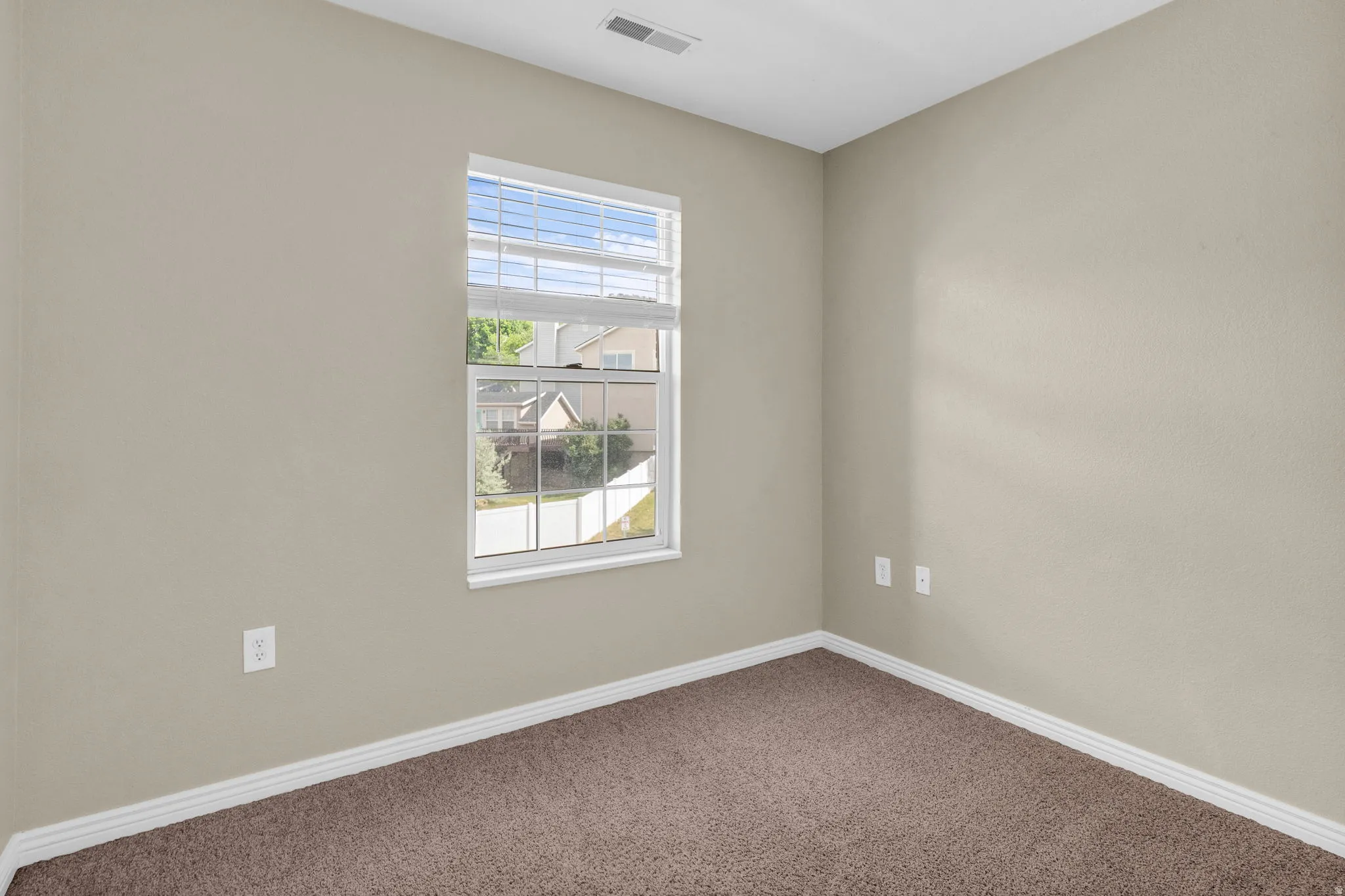 Neutral tone walls with white trim and brown carpeting