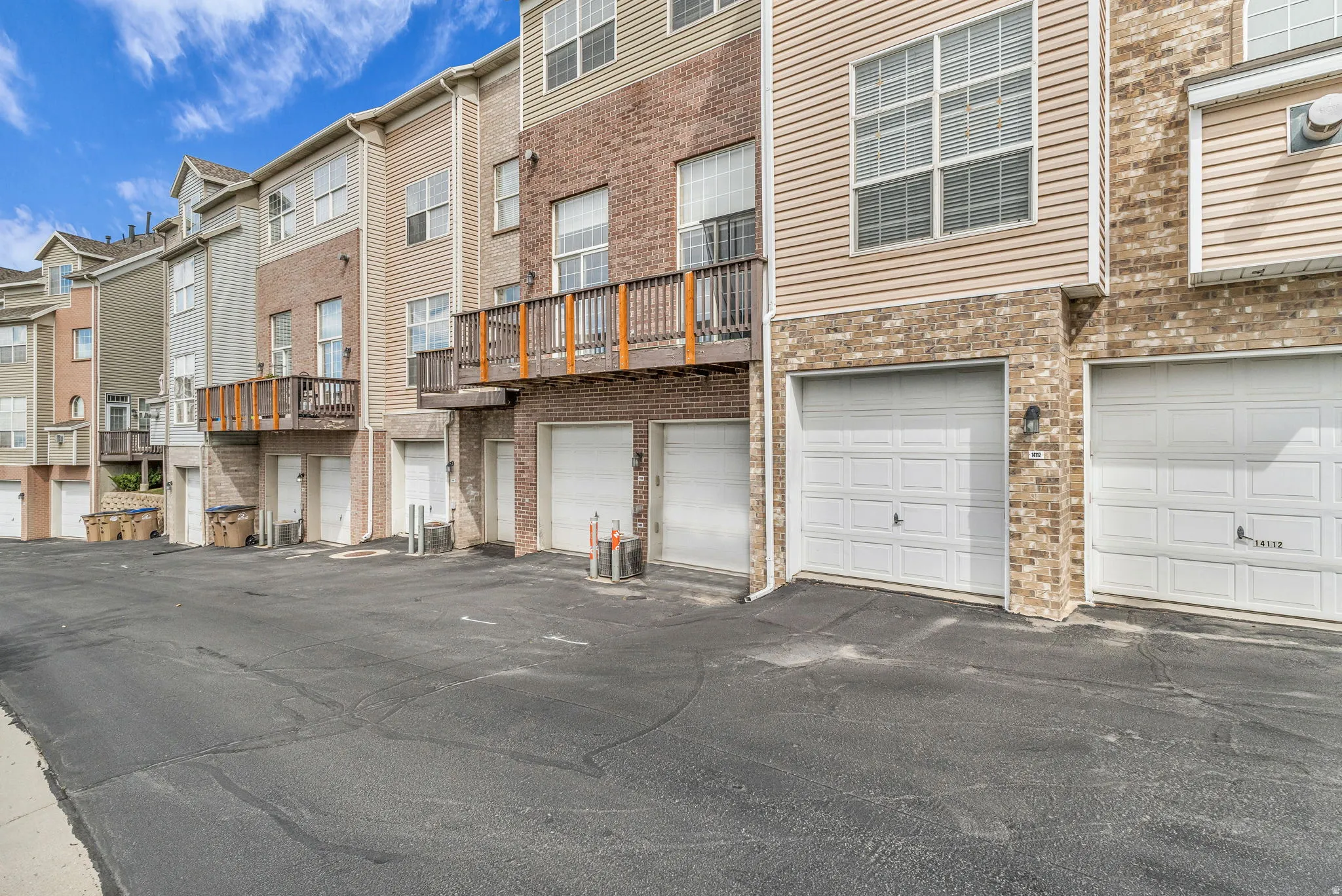 Townhome exterior featuring brick and siding facade