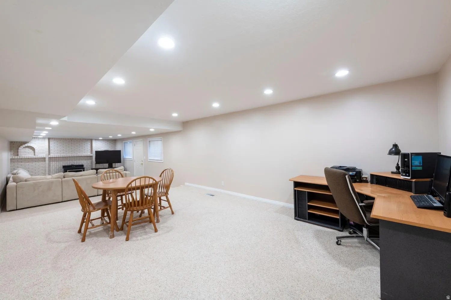 Spacious finished lower level featuring recessed lighting, light-toned carpeting, and neutral wall paint