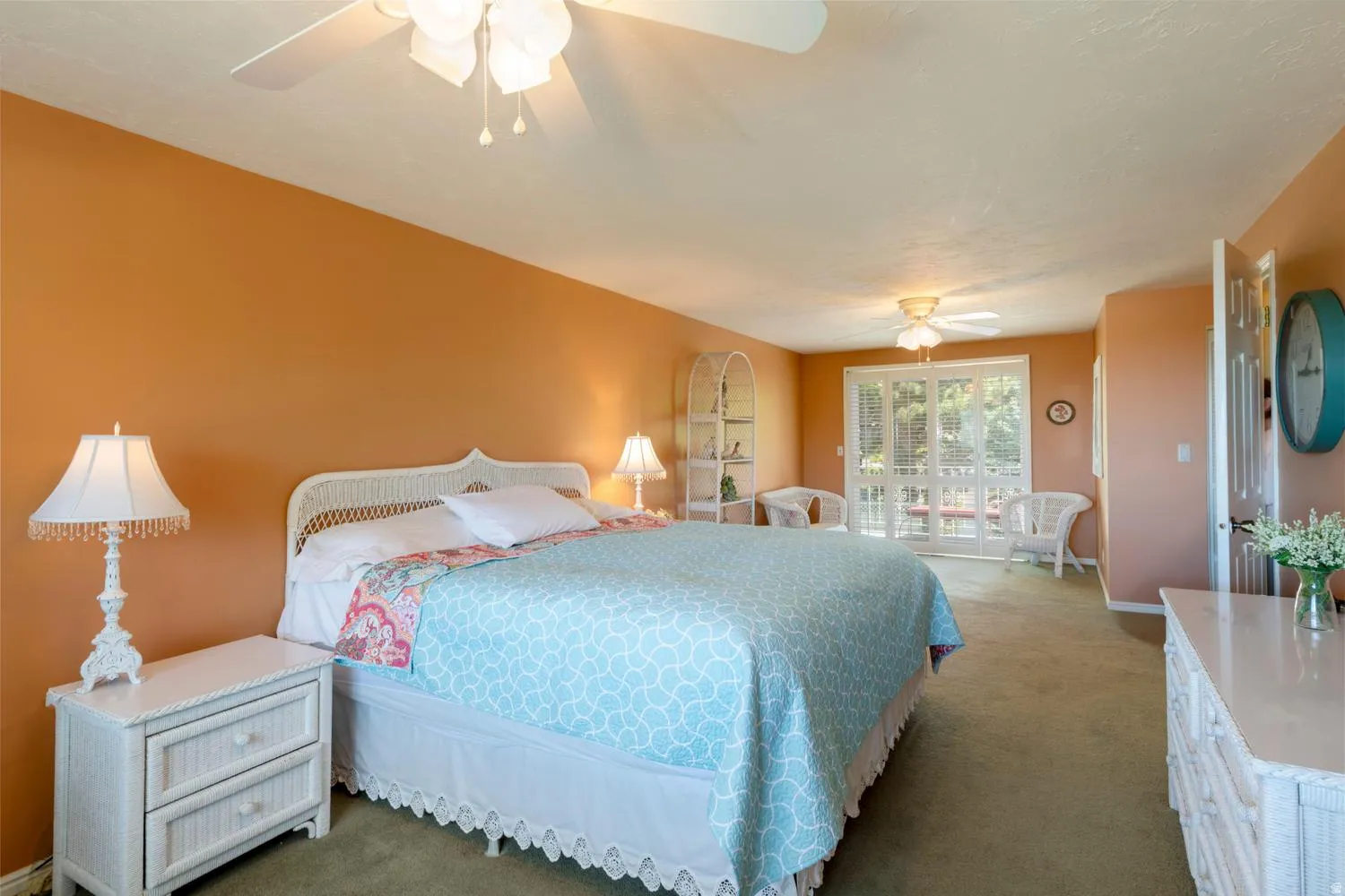 Bedroom featuring a ceiling fan, plush green carpeting, and a private balcony with glass doors
