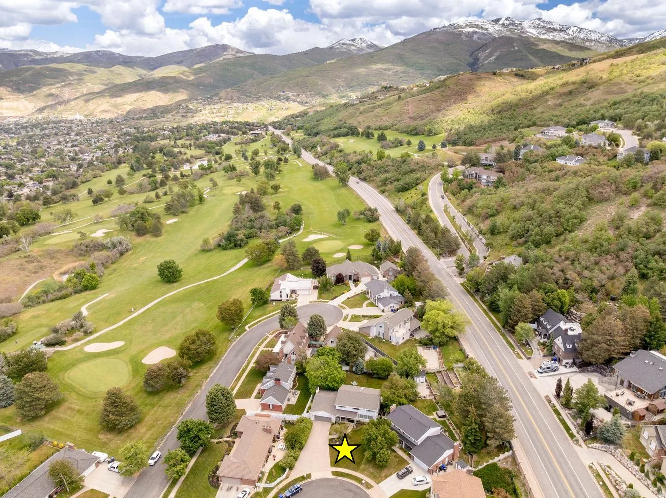 Aerial view showcasing a residential area with a prominent golf course