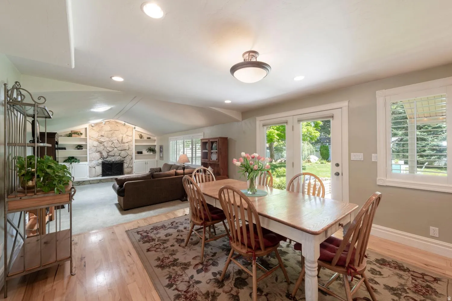 Dining area featuring wood-finish flooring, a recessed ceiling, and French doors leading to exterior space