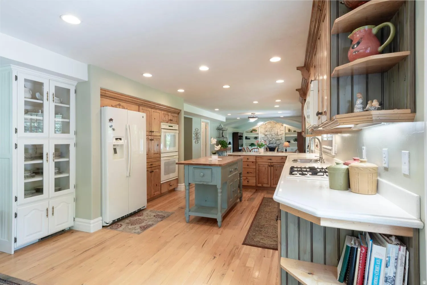 Kitchen featuring wood-finish flooring, recessed lighting, and a built-in oven