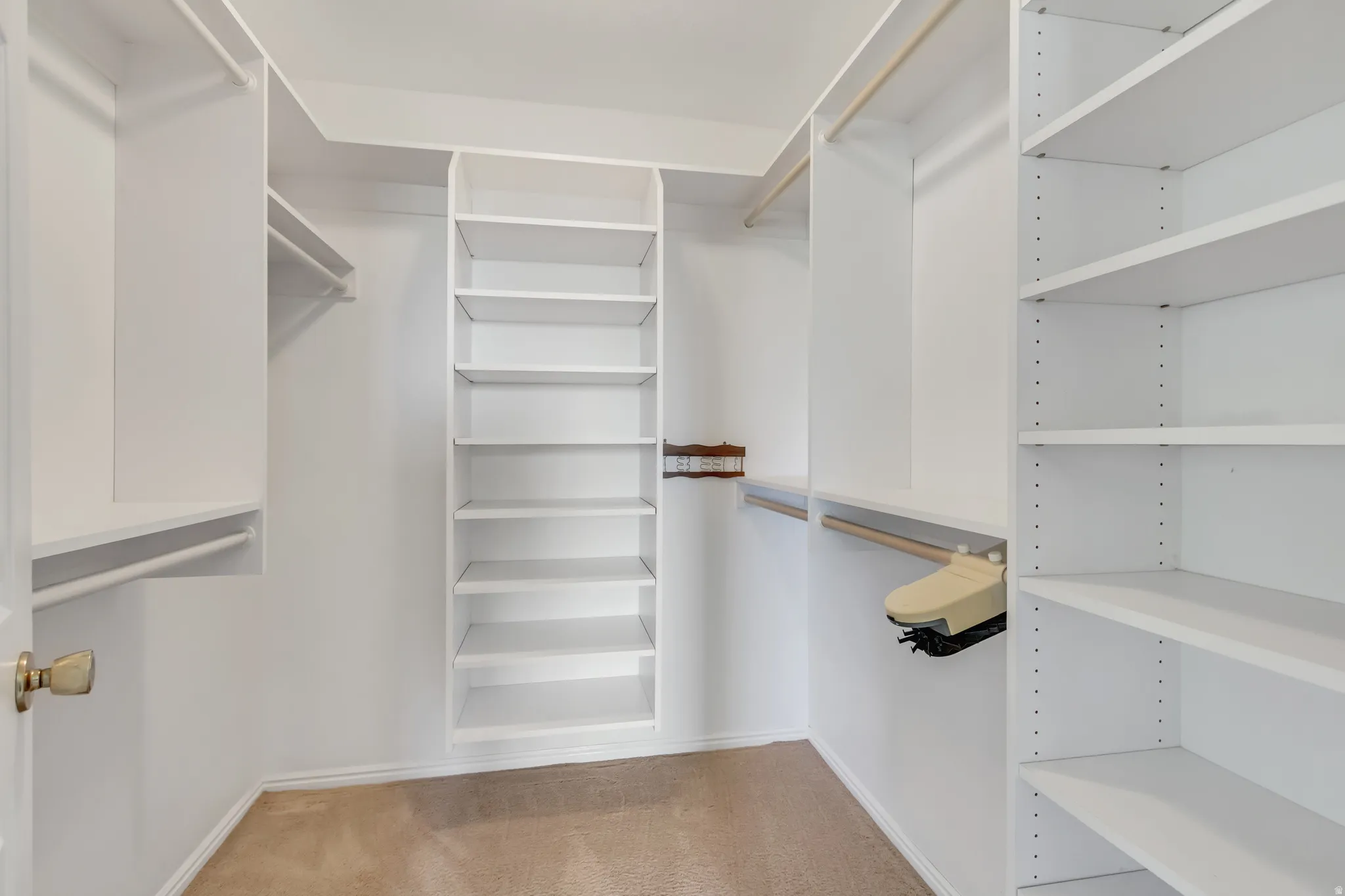 Custom closet system featuring extensive shelving and hanging rods