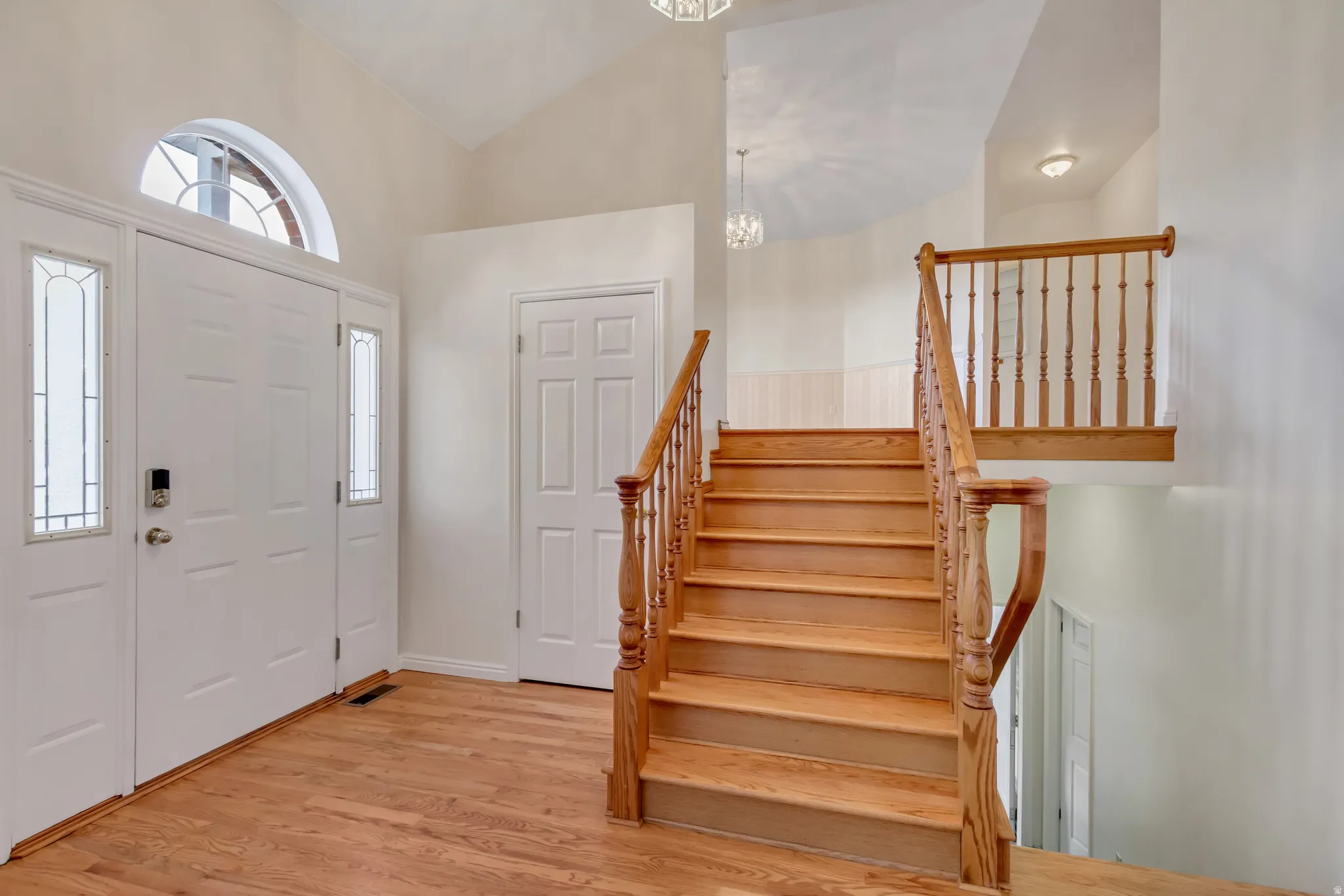 Grand entryway featuring a double door with side lites and an arched transom window