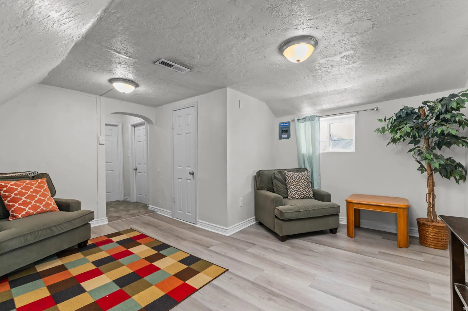 Versatile room featuring light wood-finish flooring and neutral wall tones